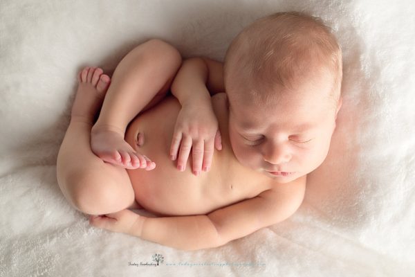 Newborn baby sleeping on soft white background