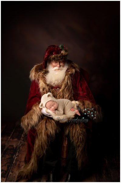 Santa holding tiny newborn baby