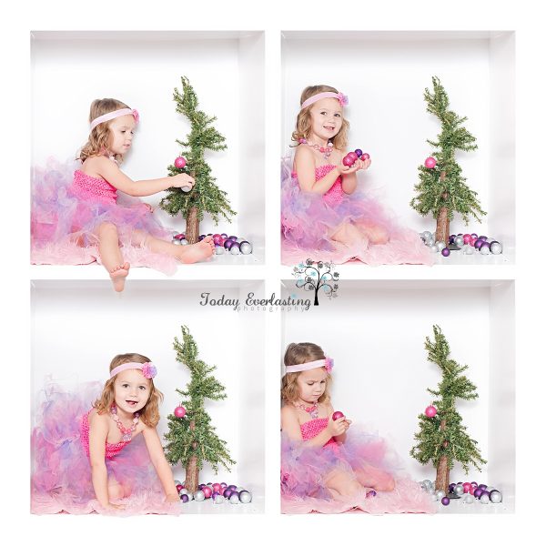 Cute little girl wearing tutu decorating Christmas tree