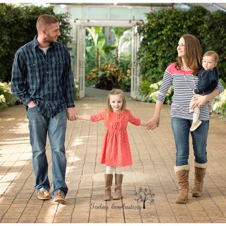 A mother, father, and their two young children are walking together.